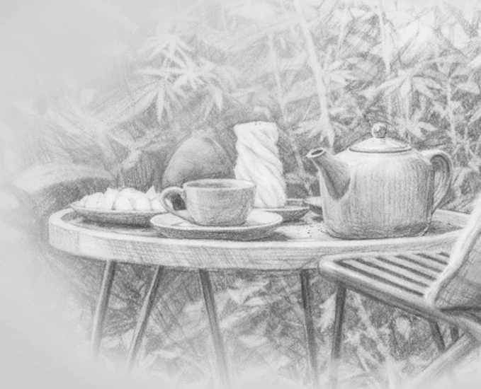 Outdoor tea setting with teapot and pastries in a garden